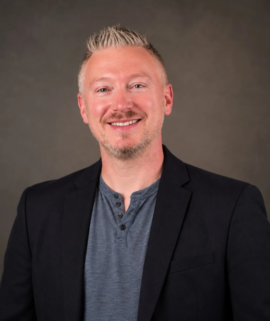 Joshua Kennon smiling in a dark blazer